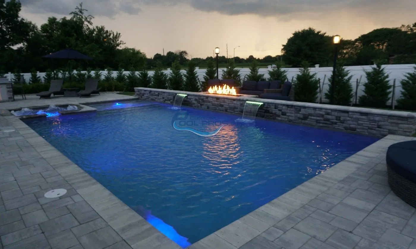 inground pool with retaining wall with water falls and fire pit installation, inground pool