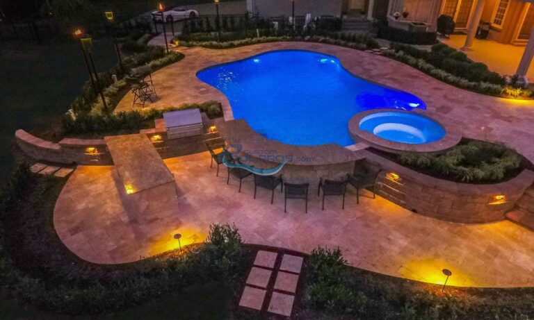 freeform inground gunite concrete pool with spa swim up bar at night with lights installation, custom inground pools, inground pool